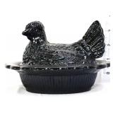 Black glass hen on nest