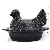 Black glass hen on nest