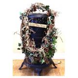 Metal oil stove w/ wreath decor