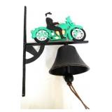 Cast iron man on green motorcycle bell