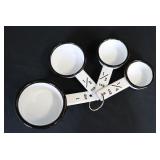 Set of white enamel measuring scoops