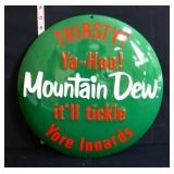 Round metal domed Mountain Dew sign