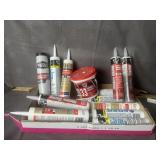 SEVERAL TUBES OF CAULKING