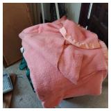 BASKET OF BEDSPREADS, COMFORTERS