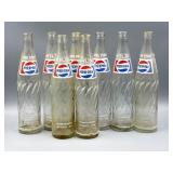 8 One Pint Pepsi Bottles.