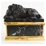 A Bronze Sculpture of a Reclining Lion on a...