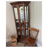 Glass Curio Cabinet with Chair and Wooden Baskets