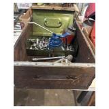 Wood crate with hand, tools, oil cans