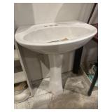 Unused porcelain pedestal sink
