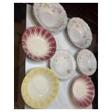Nine colorful bowls, some marked, some losses