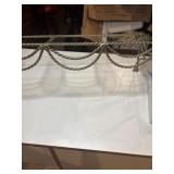 Metal and glass wall shelf with a braided metal