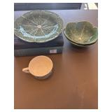 Two green cabbage bowls, plate, and two books,
