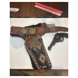 Vintage tin toy gun and 1950s Gene Autry double