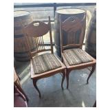 Two antique wood and upholstery chairs with a