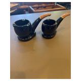 Two mid-century glossy black, ceramic pipe shaped