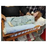 Antique articulating doll with crib