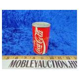 Sealed golf balls inside of a Coke can