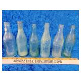Six old Coke bottles