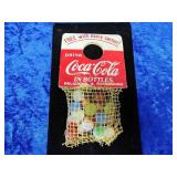 Vintage marbles that goes around the Coke bottle