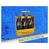 Wooden Coca-Cola six pack with old bottles