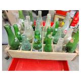 Old vintage wooden crate with collectable bottles