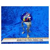 Hand blown glass artwork with metal stand