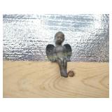 Brass Angel sits on shelf heavy