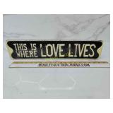 Embossed metal this is where love lives sign
