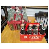 Two vintage Coke bottle holders with bottles