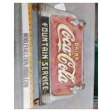 Cast iron Coca-Cola sign with brackets