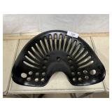 Black cast iron tractor seat