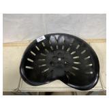 Black metal tractor seat