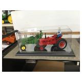 JD A & Farmall H tractors in display case