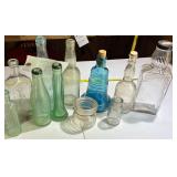 Vintage glass bottles, different colors, and sizes