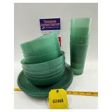 Green plastic plates, bowls, and glasses