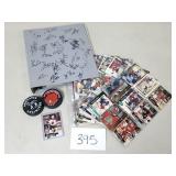 Team Signed Binder of Hockey Cards + 2 Pucks
