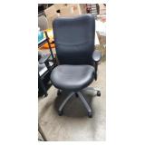Executive chair, featuring a black leather seat