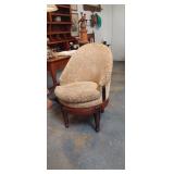 Beige floral upholstered swivel armchair bears a s
