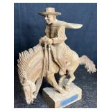 HAND CARVED WOOD COWBOY ON HORSE W/ UNREADABLE