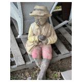 BLACK CONCRETE FISHERMAN THAT HAS HAD A ROUGH