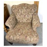floral upholstered armchair with a high back and