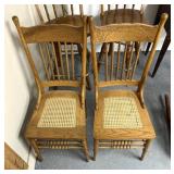 2 wooden chairs with wicker seating