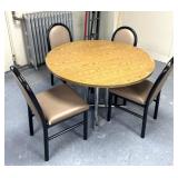 Dining table with four matching chairs, some ware