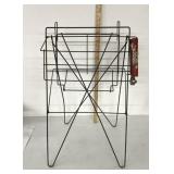 Vintage metal magazine display rack with coin