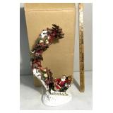 Santa Claus and his sleigh and reindeer figurines