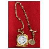 vintage square gold-tone pocket watch with a