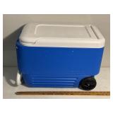 Igloo cooler chest with wheels and pole handle