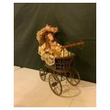 Porcelain Doll in Metal Pram