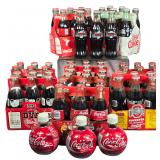 A Collection of Commemorative and Vintage Coca-Cola and Diet Coke Beverage Bottles and Carriers