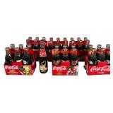 A Collection of Vintage Coca-Cola Holiday Santa Pack Commemorative Bottle Sets and Big Bear Anniversary Bottle